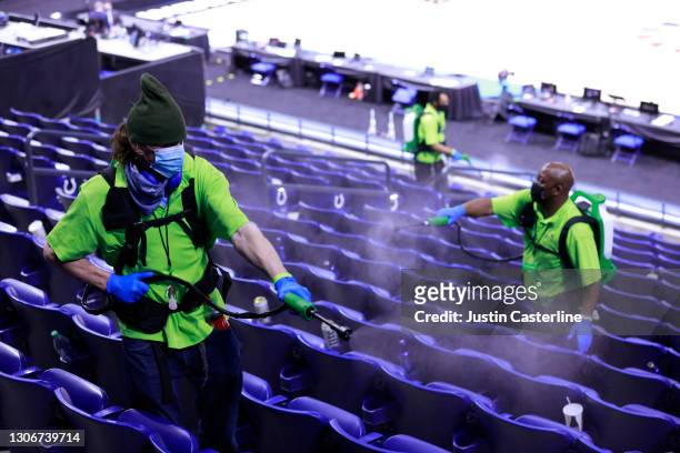 Lucas Oil Stadium employee disinfects the the seats due to Covid-19 after the game between the Purdue Boilermakers and Ohio State Buckeyes at Lucas...