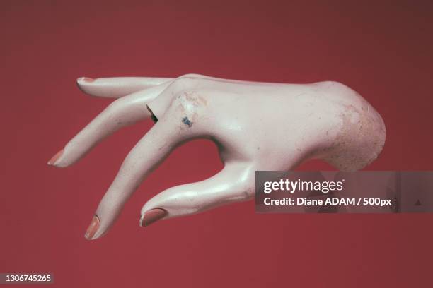 close-up of mannequin hand against red background,paris,france - mannequin stockfoto's en -beelden
