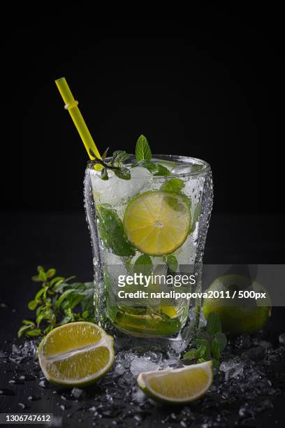 close-up of drink on table against black background - caipirinha stock pictures, royalty-free photos & images
