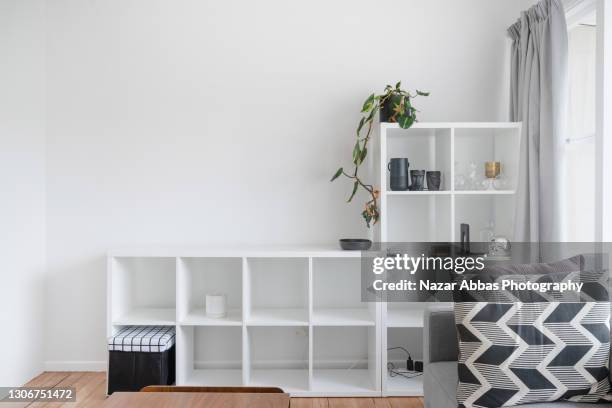 stylish shelf in living room. - bookshelf foto e immagini stock