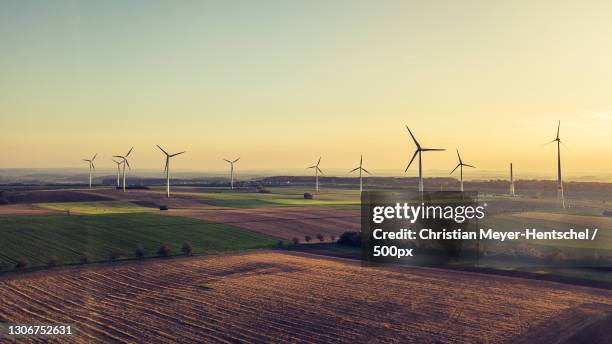 aerial view of windmills on field against sky,mettlach,saarland,germany - goldene stunde stock-fotos und bilder