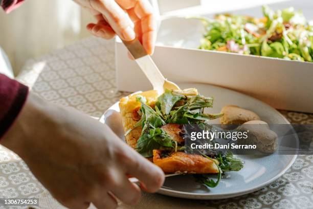 crop person serving vegan dish on plate - fougasse photos et images de collection