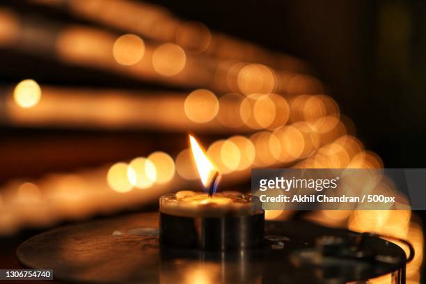 close-up of lit tea light candles in darkroom,luxembourg city,luxembourg - tea light stock pictures, royalty-free photos & images
