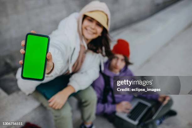 sind sie im netzwerk - student girl using laptop computer and smart phone stock-fotos und bilder