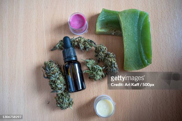high angle view of bottle with herbs and bottle on table - farmaco stock pictures, royalty-free photos & images