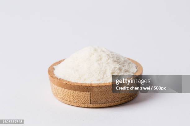 close-up of himalayan salt in wooden bowl over white background - powdered milk stock pictures, royalty-free photos & images