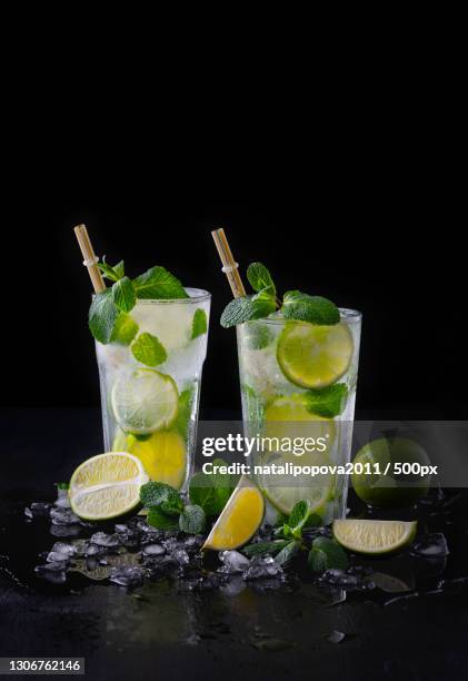 close-up of drink on table against black background - caipirinha stock pictures, royalty-free photos & images