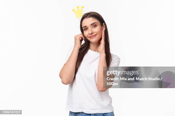 portrait of smiling woman holding party horn blower against white background - party horn blower bildbanksfoton och bilder