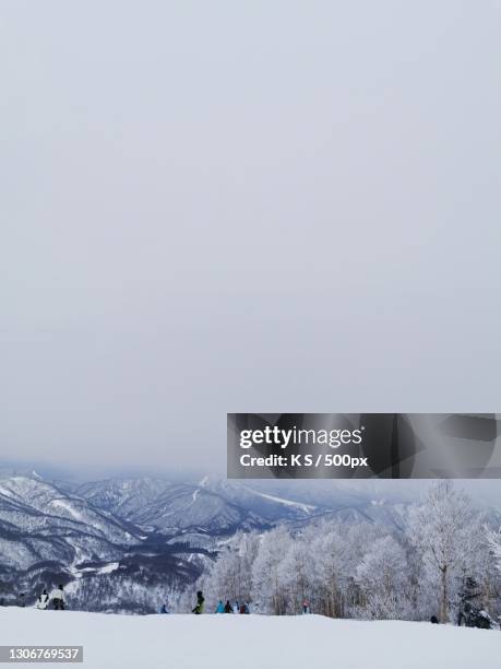 scenic view of snow covered mountains against sky,yuzawa,japan - niigata prefecture stock pictures, royalty-free photos & images