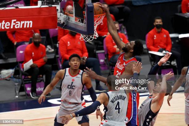Joel Embiid of the Philadelphia 76ers dunks in front of Rui Hachimura and Russell Westbrook of the Washington Wizards in the second half at Capital...