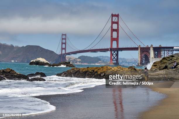 view of suspension bridge over sea,baker beach,united states,usa - baker beach stock pictures, royalty-free photos & images