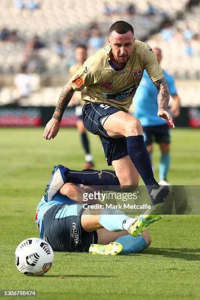 Roy O’Donovan of the Jets is tackled by Ryan McGowan of Sydney FC during the A-League match between Sydney FC and the Newcastle Jets at Netstrata...