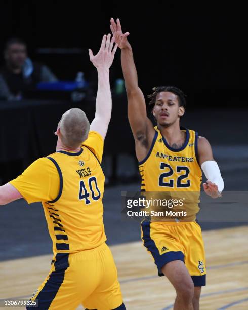 Collin Welp of the UC Irvine Anteaters high fives DJ Davis after a three-point basket during their Big West Basketball tournament semifinals game...