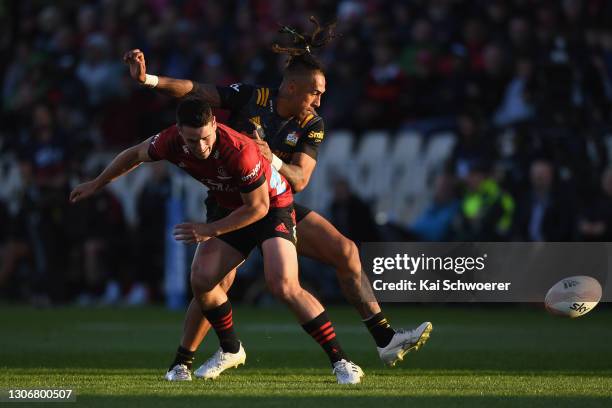 Will Jordan of the Crusaders and Sean Wainui of the Chiefs compete for the ball during the round three Super Rugby Aotearoa match between the...