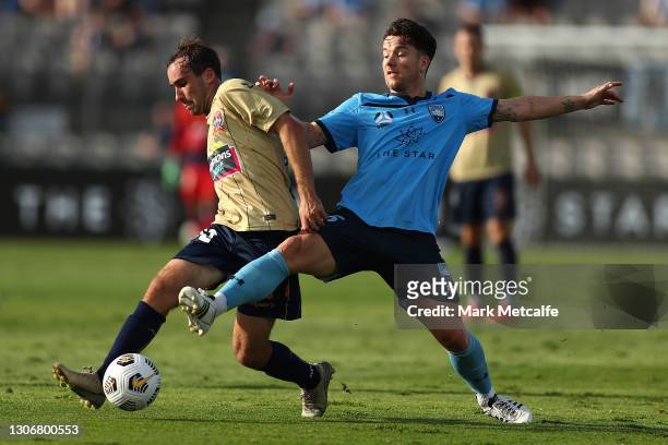 Angus Thurgate of the Jets Is challenged by Alexander Baumjohann of Sydney FC during the A-League match between Sydney FC and the Newcastle Jets at...
