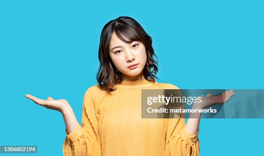 Woman Using Comparator Young Woman Comparing With Two Things High-Res Stock Photo - Getty Images