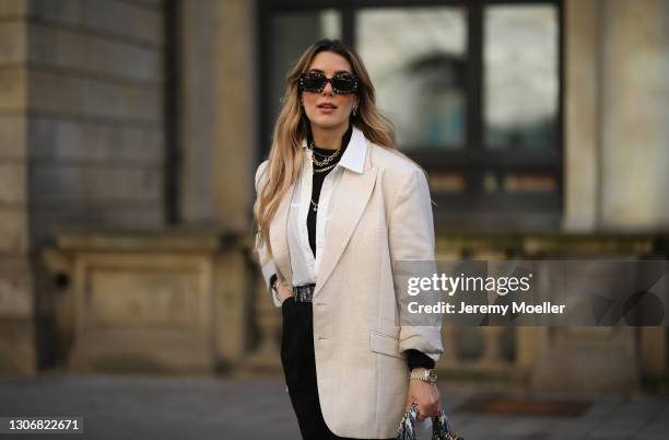 Janina Pfau wearing Marc Jacobs shades, black shirt, white & Other Stories blouse, beige Stella McCartney blazer, black WRSTBHVR pants, monogram Dior...