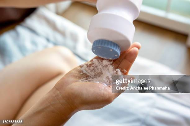 healthy problem concept: baby powder in hand, dangerous for breath system - powder foto e immagini stock