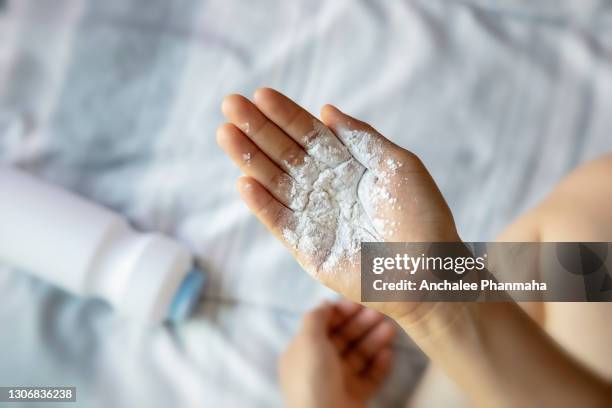 healthy problem concept: baby powder in hand, dangerous for breath system - powder foto e immagini stock
