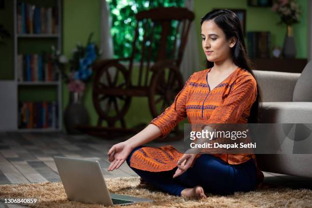 portrait of young women using laptop doing yoga at home: stock photo - zen stock pictures, royalty-free photos & images