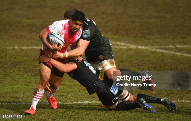 Ben Tapuai of Harlequins is tackled by Sam Skinner and Dave Ewers of Exeter Chiefs during the Gallagher Premiership Rugby match between Exeter Chiefs...