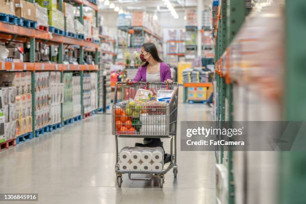 asian woman pushing her shopping cart - buying toilet paper stock pictures, royalty-free photos & images