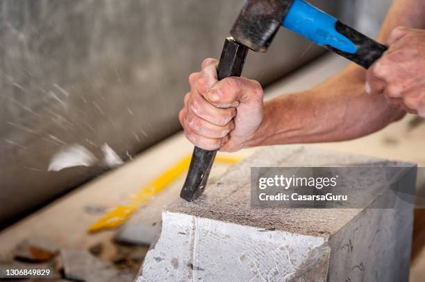 close-up of mason working with chisel and hammer on a piece of marble - mason stock pictures, royalty-free photos & images