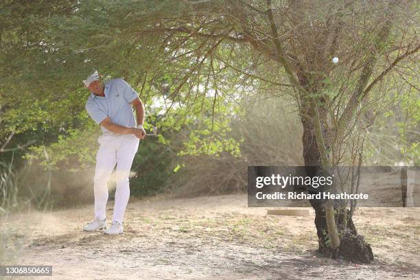 Jamie Donaldson of Wales plays from the waste area on the 17th during the third round of the Commercial Bank Qatar Masters at Education City Golf...