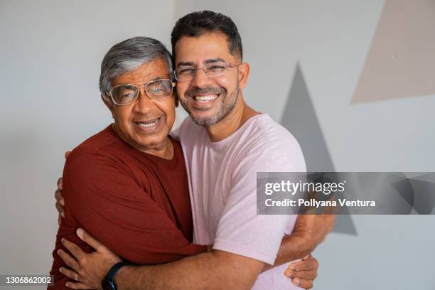 father and son hugging - adult offspring stock pictures, royalty-free photos & images