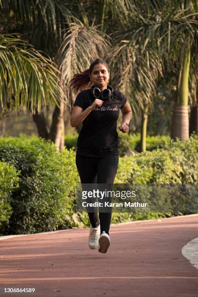 indian lady in park stock photo - jogging stock pictures, royalty-free photos & images