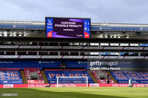 Screen inside the stadium displays the decision to check VAR for a possible penalty during the Premier League match between Crystal Palace and West...