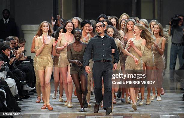 Models push fashion designer Naoki Takizawa up the catwalk at the end of the presentation of Issey Miyake's Spring-Summer 2000 Ready-to-wear...