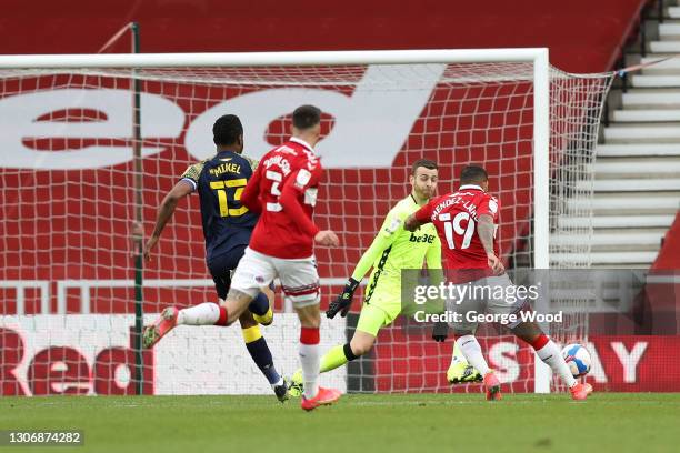 Nathaniel Mendez-Laing of Middlesbrough scores his team's third goal past Angus Gunn of Stoke City during the Sky Bet Championship match between...