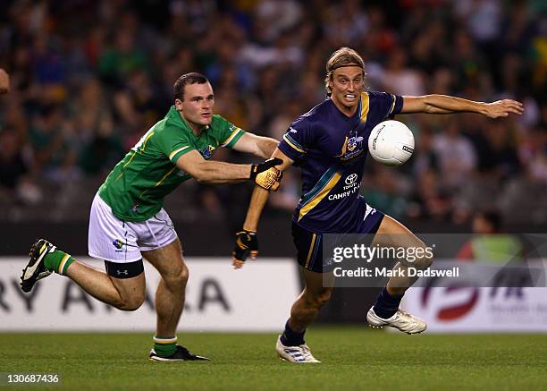 Pearce Hanley of Ireland competes with Mark Nicoski of Australia during game one of the International Rules Series between Australia and Ireland at...