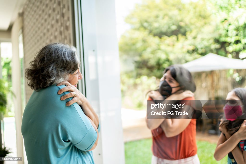 Greeted Senior Woman Being Greeted Through Window During Quarantine High-Res ...