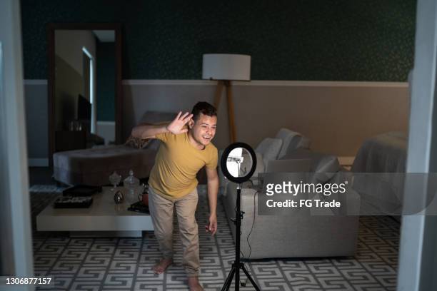 young man with dwarfism recording vlogging at home - dwarf stock pictures, royalty-free photos & images
