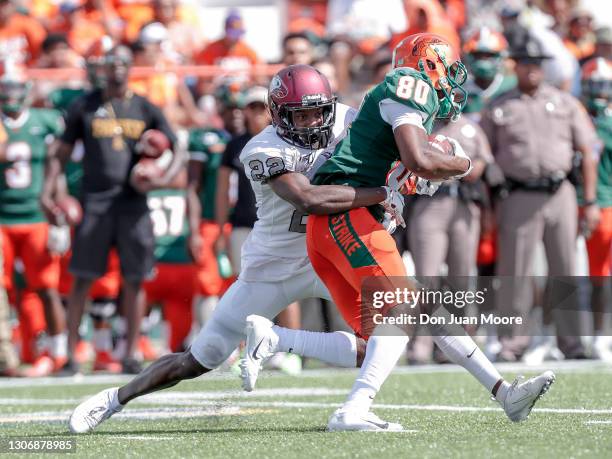 Defensive back Bryan Mills of the North Carolina Central Eagles makes a tackle on wide receiver Marcus Williams of the Florida A&M Rattlers after a...