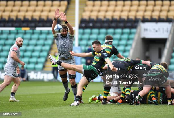 Tom James of Northampton Saints kicks the ball against Lood De Jager of Sale Sharks during the Gallagher Premiership Rugby match between Northampton...