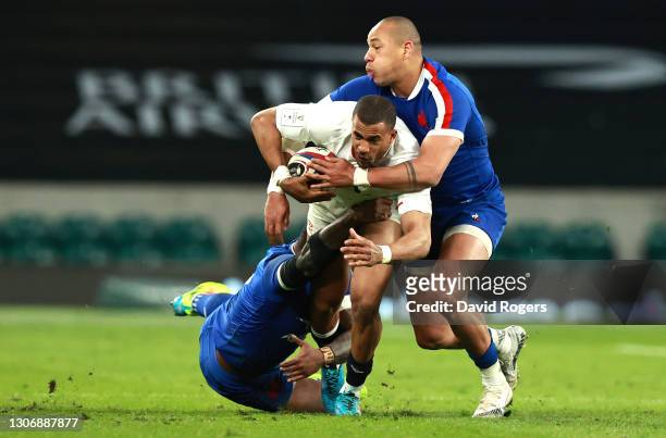 Gael Fickou and Virimi Vakatawa of France tackle Anthony Watson of England during the Guinness Six Nations match between England and France at...