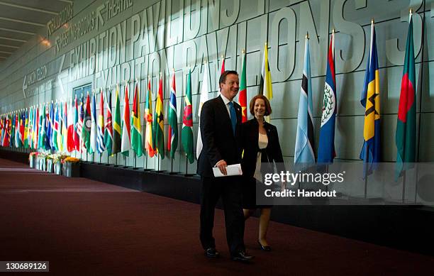 In this handout image provided by CHOGM, British Prime Minister David Cameron and Australian Prime Minister Julia Gillard walk together during the...