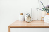 White alarm clock on wooden table with copy space...