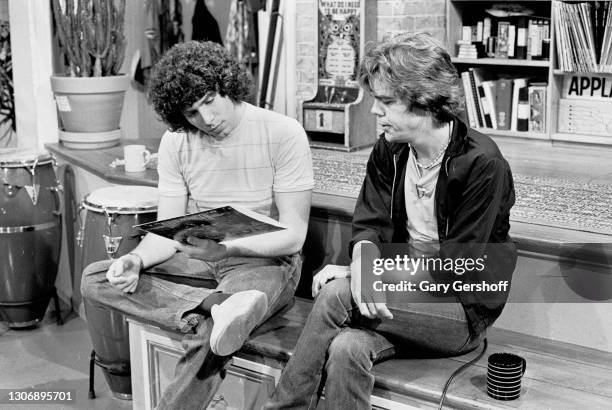 View of American VJ Mark Goodman and Rock musician David Johansen as they sit on a low stage during an interview at MTV Studios, New York, New York,...