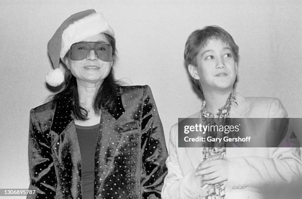 View of Japanese-born Rock, Pop, & Avant-garde musician Yoko Ono and her son , Sean Ono Lennon, onstage during the WNEW-FM Christmas Show at Madison...