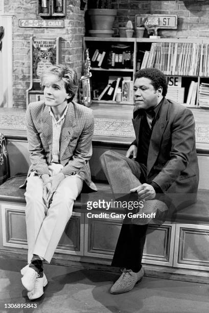 View of English New Wave musician David Sylvian , of the group Japan, and American VJ JJ Jackson as they they sit on a low stage during an interview...
