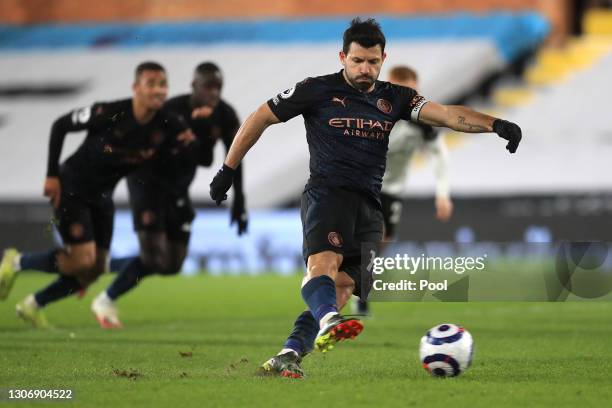 Sergio Aguero of Manchester City scores their team's third goal from the penalty spot during the Premier League match between Fulham and Manchester...