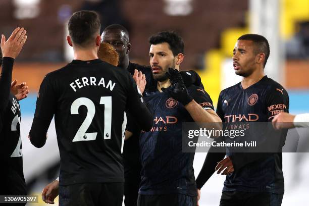 Sergio Aguero of Manchester City celebrates with teammates after scoring their team's third goal from the penalty spot during the Premier League...