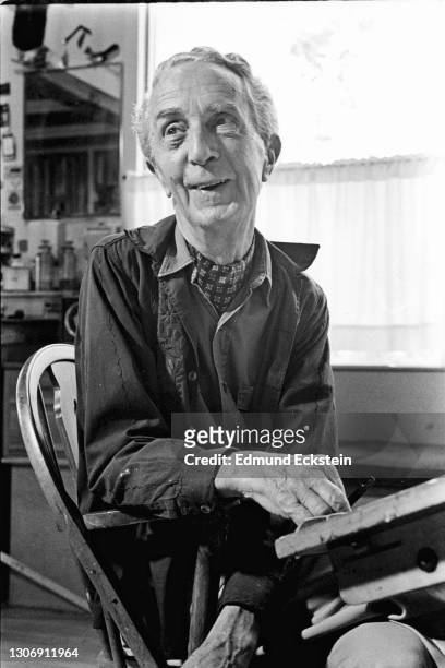 View of American artist Norman Rockwell he sits at a table in his studio, Stockbridge, Massachusetts, October 21, 1970.