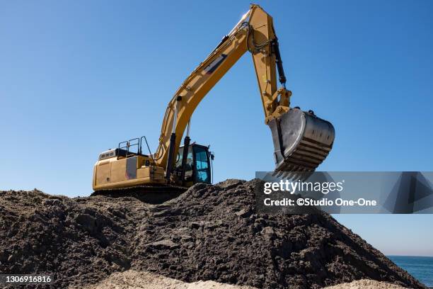 moving the bucket - reclaimed land stock pictures, royalty-free photos & images