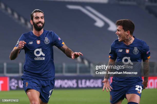 Sergio Oliveira of FC Porto celebrates with team mate Otavio after scoring a first half penalty to give the side a 1-0 lead during the UEFA Champions...