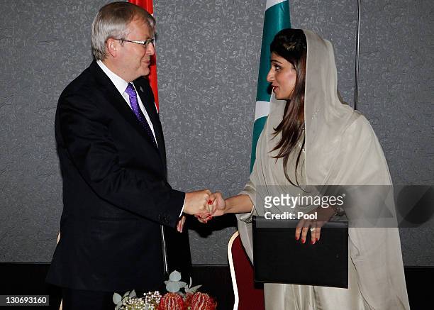 Australia's Foreign Minister Kevin Rudd shakes hands with Pakistan's Foreign Minister Hina Rabbani Khar while signing a Memorandum of Understanding...